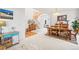 Open dining room with staircase view, a cozy dining table, and stylish décor at 6808 Silverleaf Ave, Firestone, CO 80504