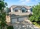 Inviting two-story home features a three-car garage, lush landscaping, and a charming exterior at 6808 Silverleaf Ave, Firestone, CO 80504