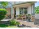Charming front porch with stone pillars, cozy seating, and decorative plants offers a welcoming entrance at 6808 Silverleaf Ave, Firestone, CO 80504