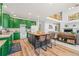 Open-concept kitchen featuring colorful cabinetry, a butcher block island, and seamless flow to the living area at 6808 Silverleaf Ave, Firestone, CO 80504