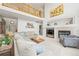 Comfortable living room with high ceilings, fireplace, and lots of natural light at 6808 Silverleaf Ave, Firestone, CO 80504