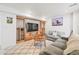 Cozy living room with built-in shelving, a modern TV, and a comfortable couch on a patterned rug at 6808 Silverleaf Ave, Firestone, CO 80504