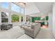 Spacious living room features soaring windows, comfortable seating, and an adjacent, open kitchen concept at 6808 Silverleaf Ave, Firestone, CO 80504