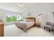 Bright primary bedroom with large windows, vaulted ceiling, and a woven headboard at 6808 Silverleaf Ave, Firestone, CO 80504
