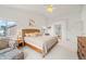 Primary bedroom suite boasting vaulted ceilings, many windows, and a seating area near the bed at 6808 Silverleaf Ave, Firestone, CO 80504