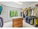 Large walk-in closet with wood drawers, and ample shelving for storing shoes, accessories, and clothing at 6808 Silverleaf Ave, Firestone, CO 80504