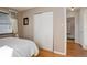 Comfortable bedroom with hardwood floors, ample storage, and a view of the ensuite bathroom at 3340 S Elm St, Denver, CO 80222