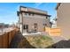 Cozy backyard featuring a small lawn, gravel area, patio, and a wood fence at 10052 Zeno St, Commerce City, CO 80022