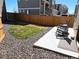 Landscaped backyard featuring a concrete patio, gravel, privacy fence, and small lawn at 10052 Zeno St, Commerce City, CO 80022