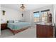 Well-lit bedroom with carpet, ceiling fan, large window and wood furniture at 10052 Zeno St, Commerce City, CO 80022