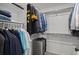Walk-in closet with clothing racks and shelving; includes a gray suitcase at 10052 Zeno St, Commerce City, CO 80022