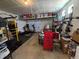 Spacious garage with overhead storage, exercise equipment, and ample storage space at 10052 Zeno St, Commerce City, CO 80022