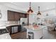 Modern kitchen featuring stainless steel appliances, granite countertops, and open layout to living area at 10052 Zeno St, Commerce City, CO 80022
