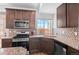 Well-appointed kitchen with stainless appliances, and stylish backsplash at 10052 Zeno St, Commerce City, CO 80022