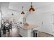 Open kitchen with a large island, stainless steel appliances, and a view into the living room at 10052 Zeno St, Commerce City, CO 80022