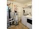 Utility room features a washer, dryer, and water heater with plumbing fixtures and white walls at 10052 Zeno St, Commerce City, CO 80022