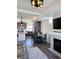 Open-concept living space features a fireplace, dining area, and seamless transition to the kitchen at 10052 Zeno St, Commerce City, CO 80022
