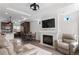 Cozy living room with fireplace, recessed lighting, open to the kitchen, and comfortable seating arrangement at 10052 Zeno St, Commerce City, CO 80022
