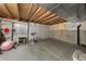 Unfinished basement area with workout equipment, exposed ceiling, and concrete floors at 9676 Whitecliff Pl, Highlands Ranch, CO 80129