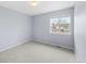 Cozy bedroom featuring light blue walls, plush carpet, and a window offering natural light at 9676 Whitecliff Pl, Highlands Ranch, CO 80129