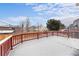 Large snow-covered deck overlooking backyard, ideal for enjoying the outdoors at 9676 Whitecliff Pl, Highlands Ranch, CO 80129