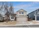 Two story home featuring a two car garage, red front door, and manicured front yard at 9676 Whitecliff Pl, Highlands Ranch, CO 80129