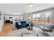 Bright living area adjacent to kitchen featuring a deck and large windows for natural light at 9676 Whitecliff Pl, Highlands Ranch, CO 80129