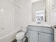 Bathroom features a shower-tub combo, single sink vanity, and white subway tile at 6870 Merseyside Ln, Castle Pines, CO 80108