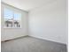 Spacious bedroom with grey carpet and large window at 6870 Merseyside Ln, Castle Pines, CO 80108