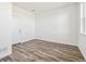 Bright bedroom with wood-look floors, white walls, and ample natural light at 6870 Merseyside Ln, Castle Pines, CO 80108