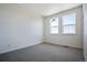 Spacious bedroom with grey carpet and two large windows at 6870 Merseyside Ln, Castle Pines, CO 80108