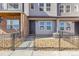 Inviting townhome front entrance with decorative rock landscaping and wrought iron fence at 6870 Merseyside Ln, Castle Pines, CO 80108