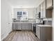 Charming kitchen with gray cabinets, stainless steel appliances, and a tiled backsplash at 6870 Merseyside Ln, Castle Pines, CO 80108