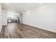 Bright, open-concept living space features wood-look flooring and flows into the modern kitchen at 6870 Merseyside Ln, Castle Pines, CO 80108