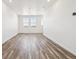 Bright and airy living room with beautiful wood-look floors and recessed lighting at 6870 Merseyside Ln, Castle Pines, CO 80108