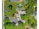 Aerial view showcasing a home's unique layout, landscaped grounds and a circular driveway at 4600 S University Blvd, Englewood, CO 80113