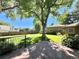 Spacious backyard featuring a lush lawn, mature tree, and a stone patio, perfect for outdoor gatherings at 4600 S University Blvd, Englewood, CO 80113
