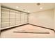 Finished basement area with white built-in shelving and neutral carpet at 4600 S University Blvd, Englewood, CO 80113
