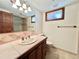 Bathroom featuring tiled countertop, vanity, shower, and toilet at 4600 S University Blvd, Englewood, CO 80113