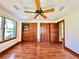 Bedroom with hardwood floors, multiple closets, and a ceiling fan at 4600 S University Blvd, Englewood, CO 80113