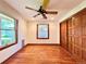 Hardwood floored bedroom with windows, built in closet and a ceiling fan at 4600 S University Blvd, Englewood, CO 80113