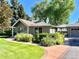 Charming home exterior with lush garden and a brick pathway at 4600 S University Blvd, Englewood, CO 80113