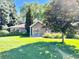 Charming home exterior surrounded by lush landscaping and mature trees, creating a serene and private setting at 4600 S University Blvd, Englewood, CO 80113
