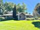 Charming home exterior surrounded by lush landscaping and mature trees, creating a serene and private setting at 4600 S University Blvd, Englewood, CO 80113