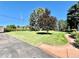 Inviting front yard featuring a lush lawn, mature trees, and manicured landscaping, enhanced curb appeal at 4600 S University Blvd, Englewood, CO 80113