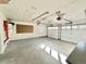 Bright garage featuring two garage doors, pegboard, shelving, and epoxy flooring at 4600 S University Blvd, Englewood, CO 80113