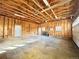 Spacious unfinished garage with lighting, door to outside, and garage door to driveway at 4600 S University Blvd, Englewood, CO 80113
