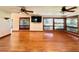Bright, spacious living room with hardwood floors, large windows, and modern ceiling fans at 4600 S University Blvd, Englewood, CO 80113