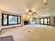Large living room with fireplace, multiple ceiling fans and windows providing lots of light at 4600 S University Blvd, Englewood, CO 80113