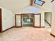 Open concept living room with large doors, skylight, and a view into another room at 4600 S University Blvd, Englewood, CO 80113